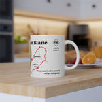 Tour du Mont Blanc milestone mug with personalised trail details, shown in a warm kitchen setting next to fruit and breakfast items.
