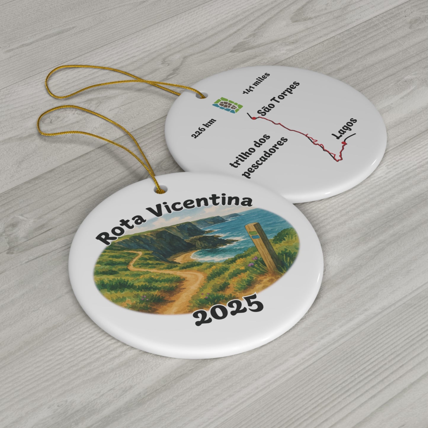 Two circular ornaments with 'Rota Vicentina' design showing front and back of Fishermen's trail design on a wooden surface