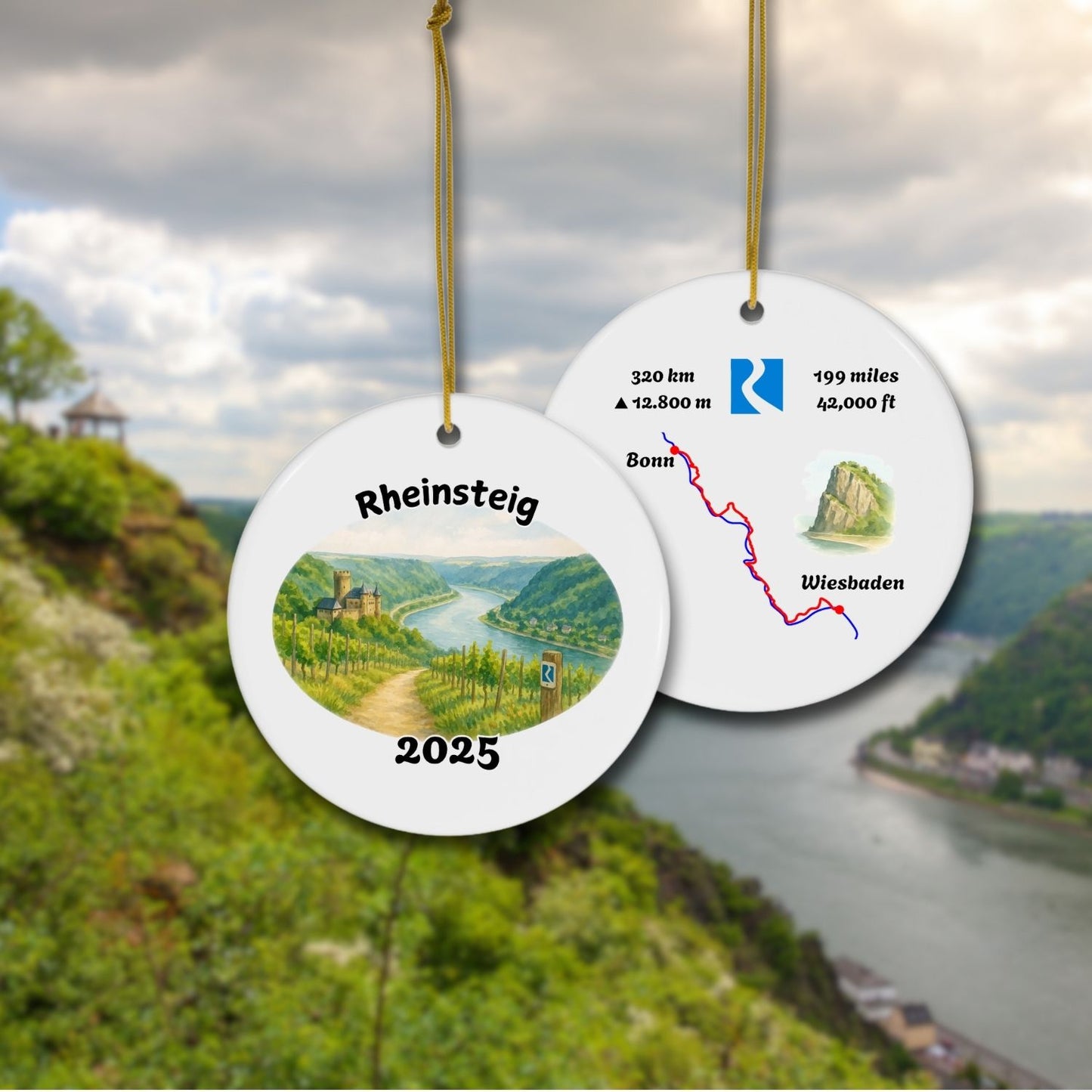 Front and back of the Rheinsteig keepsake ornament with vineyard watercolor scene and stylized trail map. Shown against a scenic Rhine Valley backdrop.